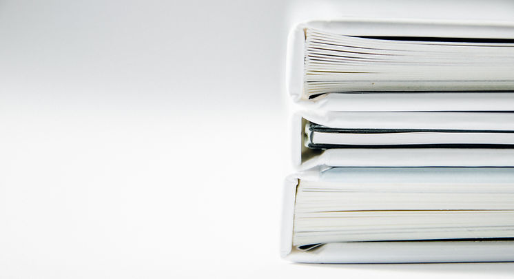 White notebooks in an even stack on the right