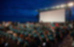 image shows deck chairs in front of a big screen. The deck chairs have the Cannes film festival logo on.