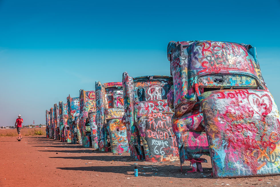 Ten Cadillacs stand nose-down in a Texas wheat field at Cadillac Ranch in Amarillo, one of Route 66's most gloriously inexplicable reasons to pull off the road. Photo by Heidi Kaden on Unsplash