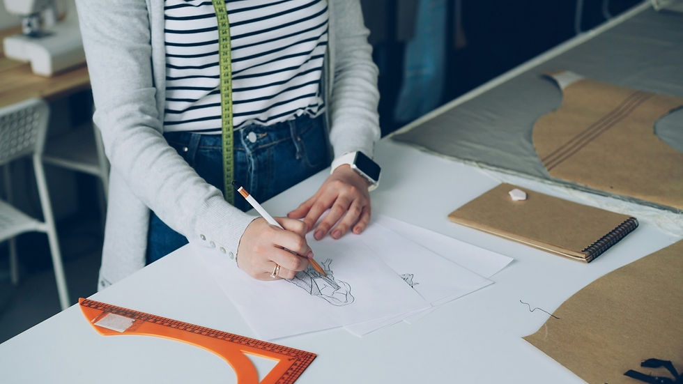 Fashion designer reviewing a clothing sample pattern and measurements