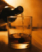 Image of pouring whiskey into glass.