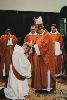 cardinal laying on hands