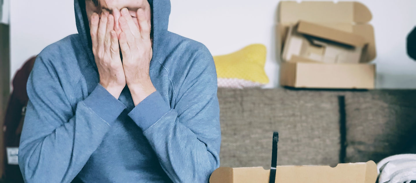 Person looking stressed surrounded by clutter in a small room