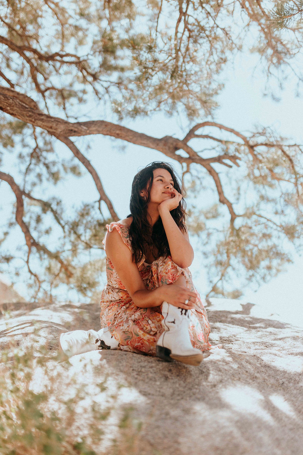 Girl sitting under tree