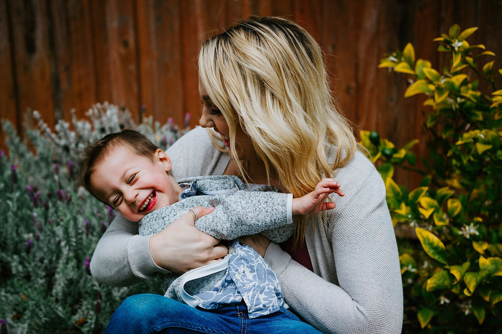 mom tickling son plants in the background