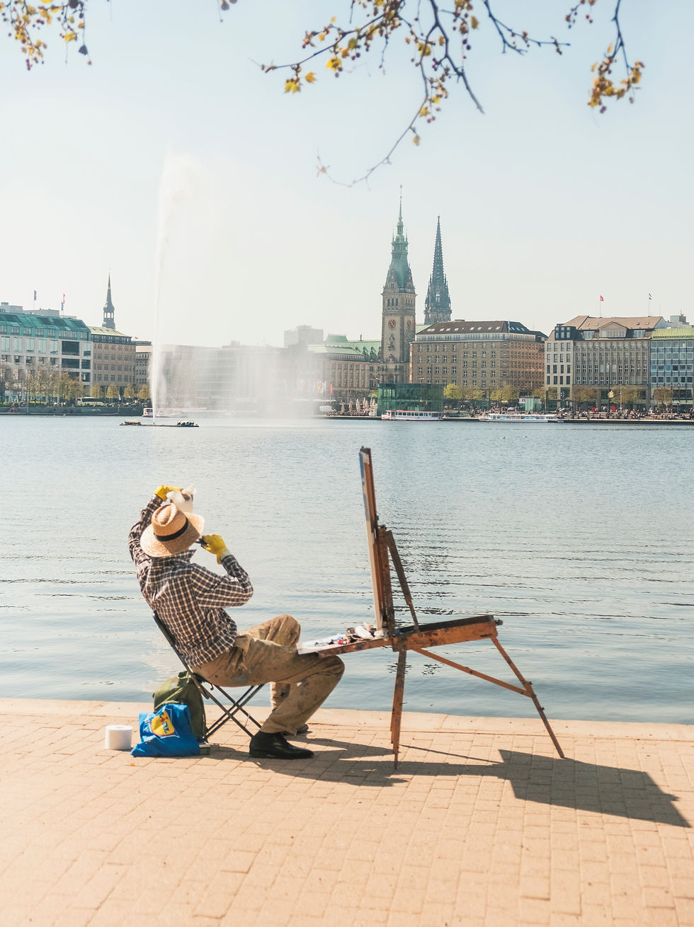 Artist painting by a lake