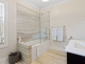 Contemporary bathroom with glossy Wetwall panels, well-lit vanity, and modern fixtures in a bright, clean design.