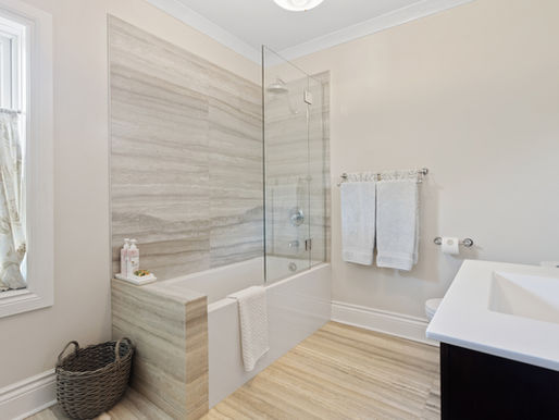 Contemporary bathroom with glossy Wetwall panels, well-lit vanity, and modern fixtures in a bright, clean design.
