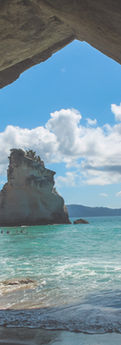 Rock arch framing the sea and a sea stack at Cathedral Cove, Coromandel