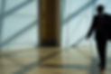 MAn walking in a hall in a suit