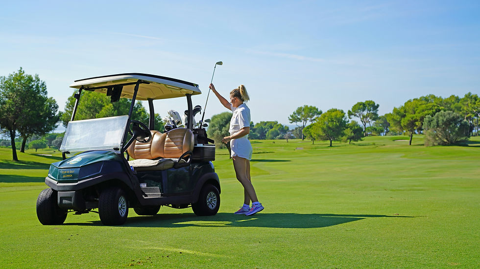 Golfer getting a golf club from their golf buggy