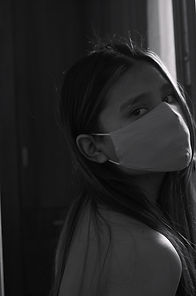 A young woman wearing a mask