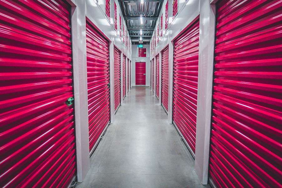 corridor of storage units with red doors