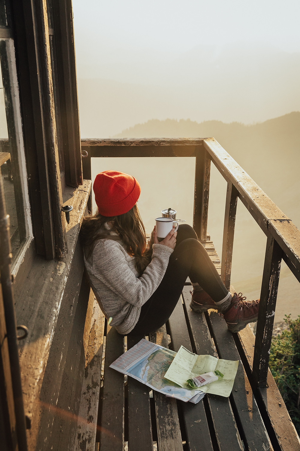 Small Business owner taking a moment to check their heading using a compass and map at a retreat.