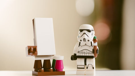 a lego stormtrooper looking at blank whiteboard