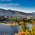 vancouver city landscape including skyscrapers, stanley park bridge and trees and mountains