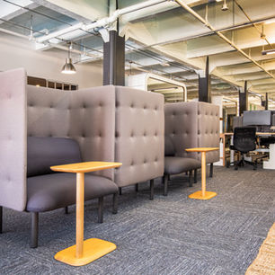 Modern office space featuring suspended ceilings exposed ductwork acoustic seating and open plan workstations designed for productivity and comfort