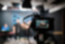 Videographer operating a camera at a live music performance