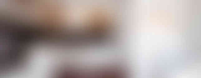 White kitchen with wooden cabinets integrates with Studio 