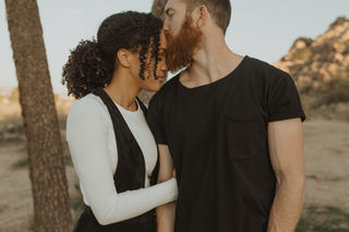 Man kisses his girlfriend on the nose