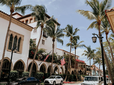 Cars parked near palm trees and a building in South Florida
