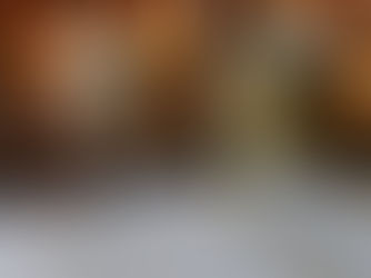 Open Bible with candlelight and a simple nativity silhouette, symbolizing a Christ-centered Christmas.