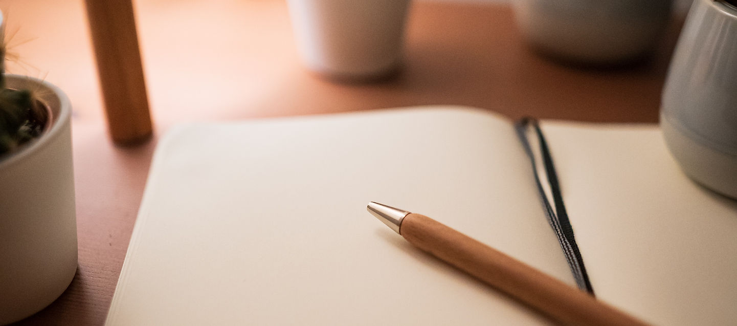 A pen and notebook in a calm space, suggesting taking charge of one’s personal story.