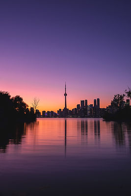 An image capturing Toronto's skyline with the CN Tower prominently displayed. The scene is composed to visually represent the concept of 'Crypto License Canada' without any text, focusing on elements that symbolize the intersection of Canadian finance and cryptocurrency innovation.