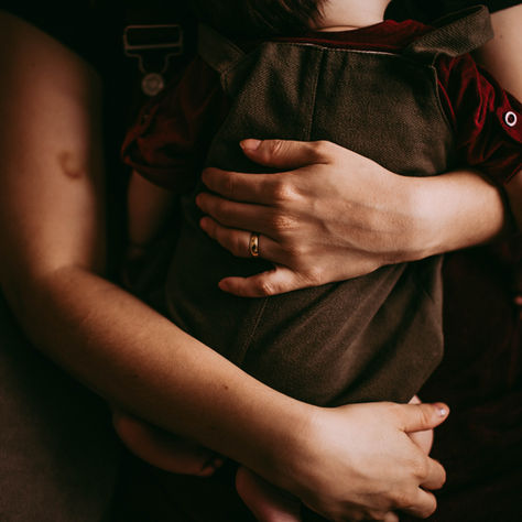 Baby securely held in a baby carrier. Babywearing can be a win for any adult/baby pair.