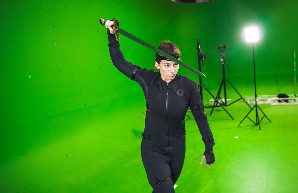 A woman with a sword infront of a greenscreen