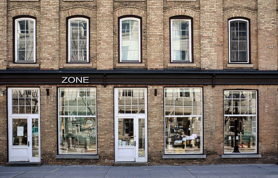 brick exterior of a building and a sign with text Zone