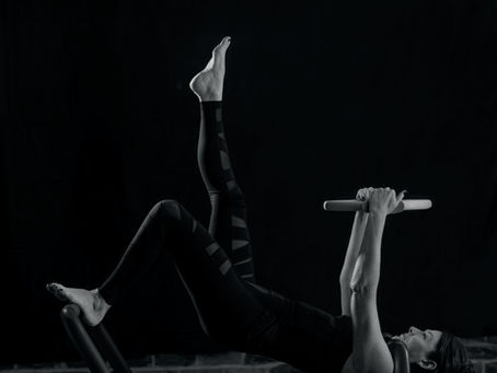 Pilates single leg bridge with fitness circle on reformer