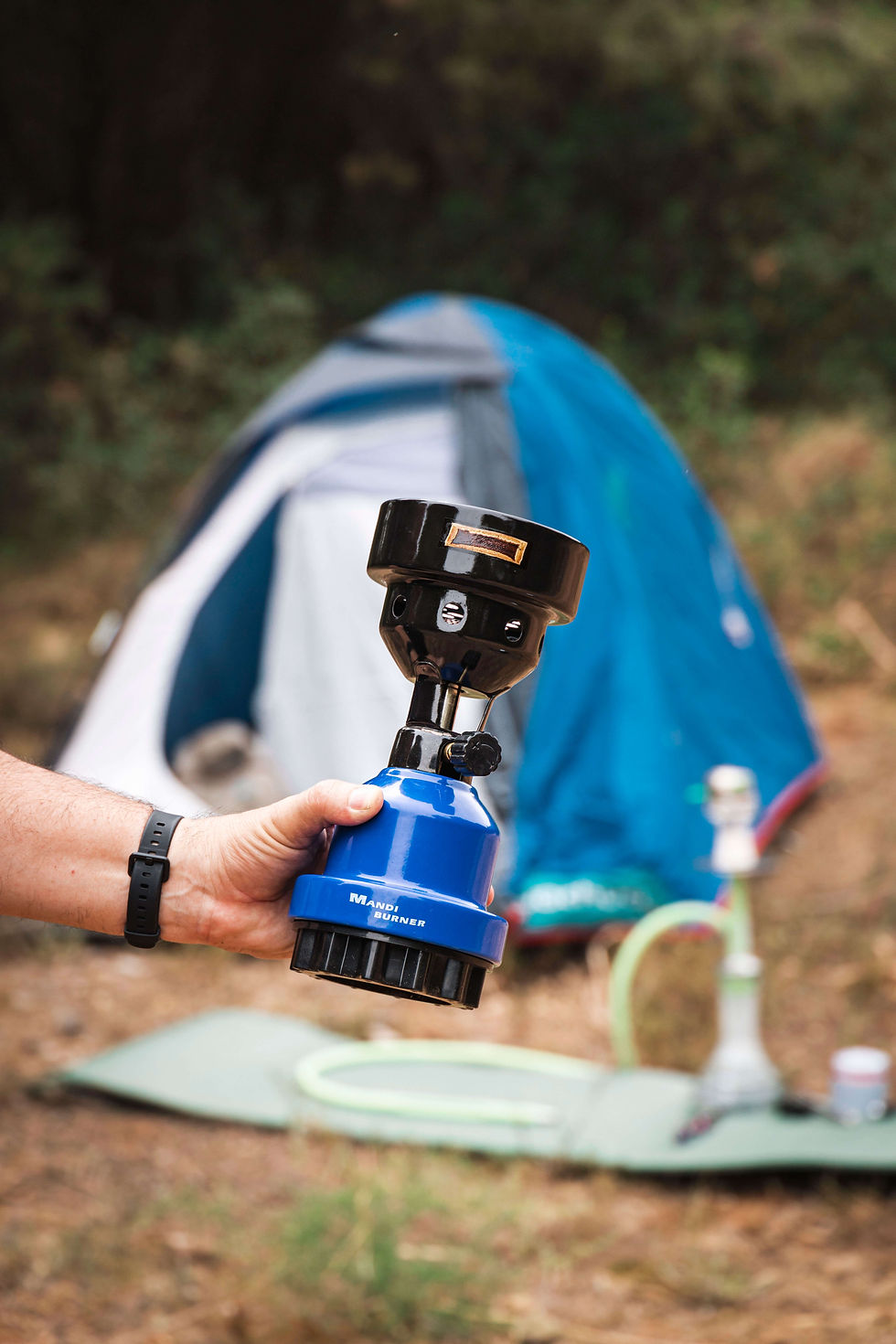 A man holding a camping stove