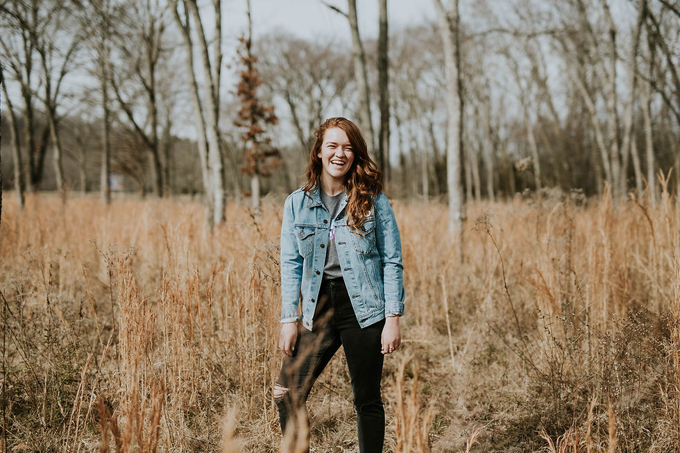 Woman standing in field in fall
