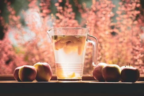 Experience the Essence of Summer: Cool off on a scorching summer day with our refreshing offering - crisp, chilled water infused with freshly sliced apples. Picture-perfect moments await as you take in the vibrant hues of sliced fruit against a backdrop of elegant peach-colored flowers, all set on a stylish wooden table. Indulge in the ultimate hydration experience, infused with the passion and freshness that define our brand.