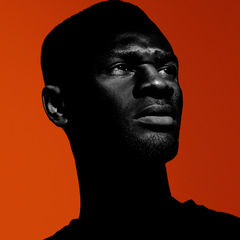 Dramatic profile image of man with high contrast and red gradient background, 