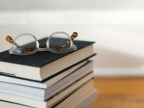 Glasses on a pile of books