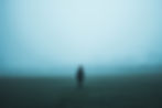 a person standing against a foggy background