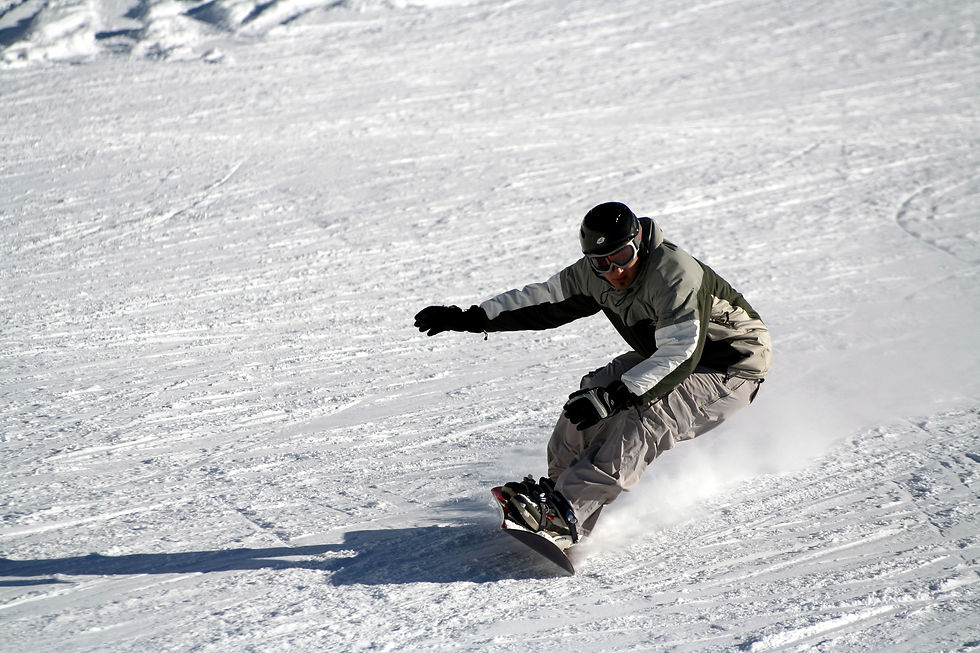 Beginner Snowboarder riding down the mountain