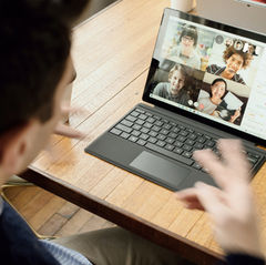 man connecting with his four group members on a Zoom call