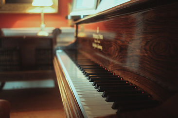 Wooden piano case and keyboard viewed from the side