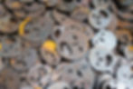 A pile of metal plates that looks like faces.