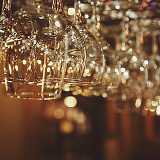 Wine glasses hanging upside down in a restaurant - Image by Trevor Gerzen