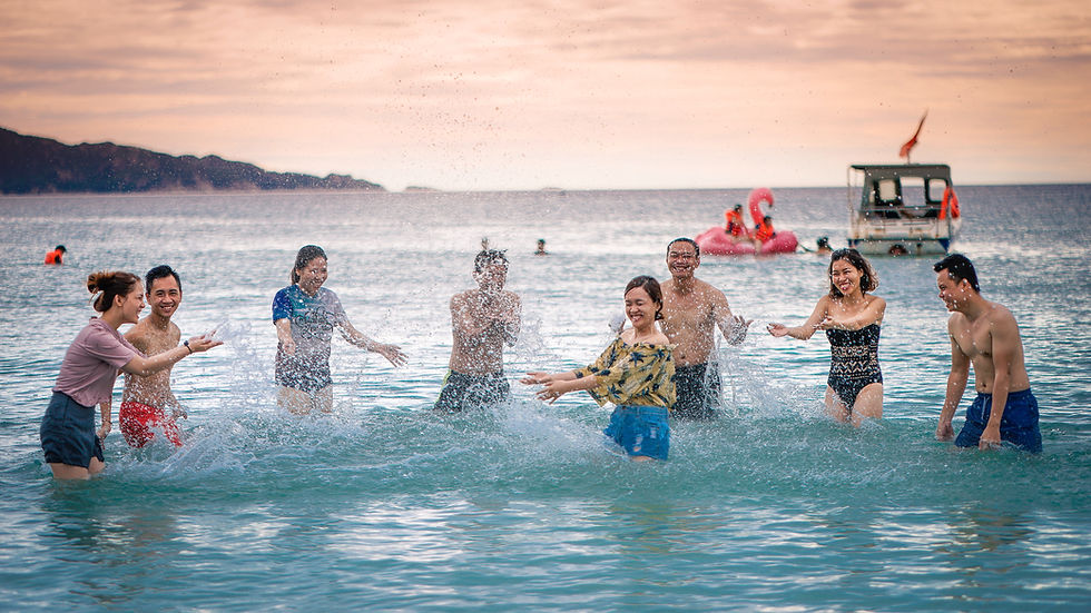 a group of people splashing water on each other in a beautiful ocean