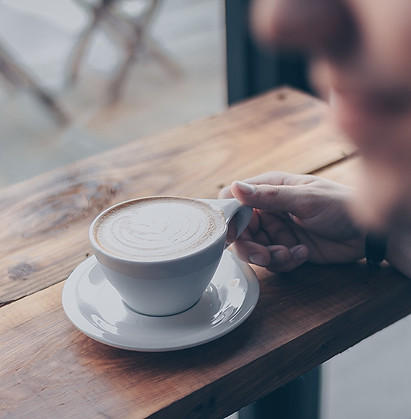 Man holding a cup of mushroom coffee