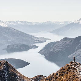 The necessity to commercialise aspects of New Zealand's national parks to achieve sustainable funding New Zealand's national parks are vital ecological and recreational assets, but they face significant funding shortfalls. The Department of Conservation (DOC) struggles to secure sufficient financial resources to maintain and protect these lands. Meanwhile, the demand for commercial recreation on public conservation lands has grown considerably over the past three decades, making it a necessary tool for sustainable funding. However, the commercialisation of national parks remains a contentious issue, with many holding outdated views that fail to acknowledge the economic realities and conservation benefits of well-managed commercial operations. This article explores the necessity of commercialising aspects of New Zealand's national parks, the concerns surrounding this approach, and recommendations for a balanced, sustainable strategy. The funding shortfall and the need for commercialisation The DOC faces a critical funding gap that threatens the sustainability of New Zealand’s national parks. Conservation efforts require significant investment in infrastructure, habitat protection, visitor facilities, and ecological monitoring. Traditional funding sources, such as government allocations and philanthropic contributions, are insufficient to meet these growing needs. By incorporating commercial recreation activities in a responsible and sustainable manner, the DOC can generate additional revenue to support conservation efforts without compromising environmental integrity. As DOC faces funding shortfalls, it has been floating new money-raising ideas such as charging at car parks and consulting on fees for access to some public conservation land. Despite the growing need for revenue, DOC’s departmental budget increased from $402 million in 2017/18 to $710 million in the last financial year. However, funding increases have been absorbed by rising costs or allocated to ring-fenced programmes. The department administers New Zealand's largest recreation network, which includes more than 14,000km of tracks, 326 campsites, approximately 950 backcountry huts, and numerous heritage sites across one-third of the country. The future of nearly a third of all huts and tracks managed by DOC is uncertain, as the agency faces a 30 percent shortfall in funding needed to maintain them. The department is reviewing its visitor network—including huts, tracks, car parks, signs, and public toilets—to address the financial deficit. The network currently comprises 15,000 kilometres of track (longer than all of New Zealand's state highways combined), 950 huts, 300 campsites, and over 2,000 toilets. Budget 2024 saw a decrease in funding from previous years, including cuts to programmes, leading to a total reduction of $134 million. The agency was required to find savings of 6.5 percent as part of government cost-cutting measures, amounting to $31.3 million per year from 2024/25, and announced job reductions. While this does not necessarily mean a 30 percent reduction of the network, cuts are under consideration. Asset removal would be a last resort, but options such as introducing paid car parking trials and consulting on access charges are being explored. Climate change is further exacerbating maintenance costs, with increasing expenditures on storm damage repairs. For example, Cyclone Gabrielle inflicted $90 million in damages to approximately 500 assets. Ensuring visitor safety and long-term sustainability requires a reevaluation of which tracks and facilities are financially viable in the face of recurring climate-related damage. Lessons from the UK: alternative funding models for public parks In the UK, public parks are an essential part of the social and ecological fabric of communities, providing significant economic, social, and environmental benefits. However, similar to New Zealand’s national parks, they face funding challenges due to reductions in public subsidies. In response, innovative business models have been implemented to ensure long-term sustainability. Key approaches include: Generating income through concessions and events : Public parks in the UK host paid events, food stalls, and recreational concessions, generating revenue to support park maintenance. Encouraging community-led management : Several parks have transitioned to local co-operatives, trusts, or social enterprises, fostering local ownership and diversified funding sources. Diversifying revenue streams : Parks in the UK have explored new income sources, such as eco-tourism activities, environmental services, and even taxation models that ensure long-term funding. Exploring commercial developments : Some urban parks have incorporated commercial spaces, such as cafes and event venues, to enhance visitor experiences while generating sustainable revenue. New Zealand can adopt similar strategies to diversify funding streams while preserving the natural integrity of national parks. The evolving role of commercial recreation in national parks Commercial recreation on public conservation lands has become widely accepted, with various benefits: Revenue generation : Fees from commercial operators provide a direct source of funding for park maintenance and conservation. Enhanced visitor experiences : Guided tours and outdoor adventure services offer structured, safe experiences for visitors. Economic benefits : Commercial recreation creates jobs and stimulates local economies through tourism. Despite these advantages, opposition to commercialisation persists. Many critics argue that commercial recreation undermines independent recreation and could lead to excessive development. However, these concerns can be mitigated through careful management and regulation. Concerns and misconceptions about commercialisation Fear of over-commercialisation Some believe that increased commercial activity will transform national parks into profit-driven enterprises. However, commercial operations can be limited in scale and designed to align with conservation goals. Impact on independent recreation There is a perception that commercial visitors disrupt independent experiences. While conflicts may arise, strategies such as zoning and visitor education can help maintain a balance. Environmental degradation Concerns over noise, overcrowding, and habitat disturbance are valid. However, well-managed commercial activities can enforce sustainability standards, often more effectively than independent use. Opposition to private profit from public lands Some object to businesses generating revenue from public resources. However, structured concession fees ensure that commercial operators contribute financially to conservation efforts. Recommendations Develop a sustainable funding model Introduce higher concession fees for commercial operators to ensure a steady revenue stream for conservation projects. Adopt a balanced policy framework Establish guidelines that balance commercial and independent recreation needs while prioritising conservation. Monitor and evaluate commercial activities Implement regular assessments of commercial operations to ensure compliance with environmental and visitor experience standards. Engage stakeholders in decision-making Include conservation groups, recreationists, local communities, and tourism operators in policy discussions to create consensus-driven solutions. Invest in infrastructure to support sustainable tourism Use revenue from commercial activities to maintain and improve park facilities, ensuring long-term visitor satisfaction and environmental protection. Conclusion The commercialisation of aspects of New Zealand's national parks is not only necessary but also beneficial when managed responsibly. Given the DOC's significant funding shortfall, leveraging commercial recreation can provide a sustainable financial model that supports both conservation and public access. Lessons from the UK demonstrate the potential for innovative funding models, ensuring public conservation lands remain financially viable and ecologically preserved. A well-balanced approach will secure the future of New Zealand’s national parks for generations to come.