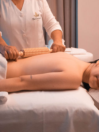 Woman receiving lymphatic drainage massage in a calm wellness spa in Bali