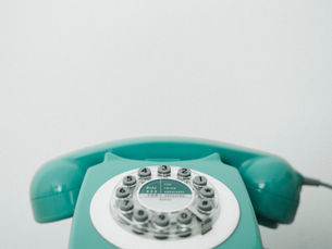 Pink rotary phone not in use.