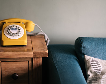 Vintage telephone in a cozy room, symbolizing comfort and connection.