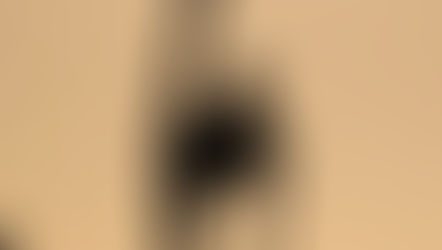 Silhouette of a person performing a high leg stretch on rocky terrain at sunset, with a serene orange gradient background, promoting relaxation and wellness through magnesium supplementation for muscle recovery and sleep support.